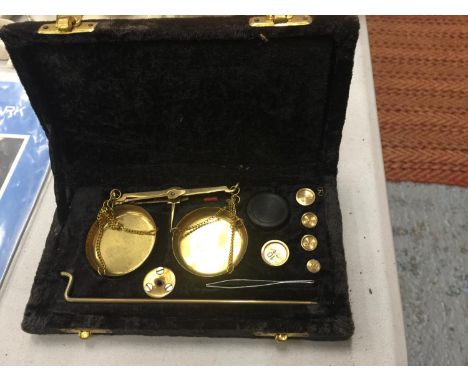 A SET OF BOXED BRASS JEWELLERY SCALES WITH WEIGHTS 