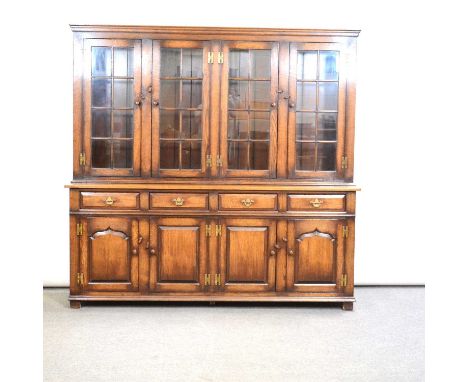 Large oak bookcase by Titchmarsh &amp; Goodwin, moulded cornice above four glazed doors, the base with four drawers over pane