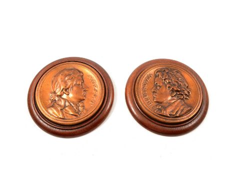 Pair of brass portrait plaques, Mozart and Beethoven, on oak plaques, diameter 23cm.Qty: 2