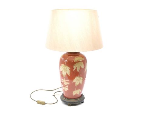 Contemporary table lamp, ovoid glazz body decorated with autumn leaves, with shade, overall height 67.5cm.