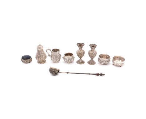 Small collection of Indian silver, variously embossed and decorated with figures and scrolls, including a pair of candlestick