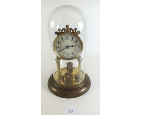 A gilt metal tortion clock with glass dome
