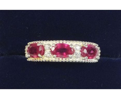 A silver and ruby ring