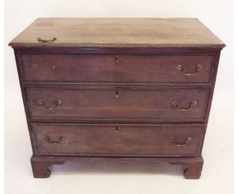 A Georgian oak chest of three drawers on bracket feet