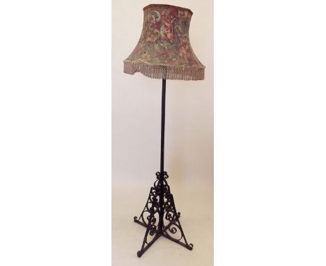 A Victorian cast iron standard lamp and shade