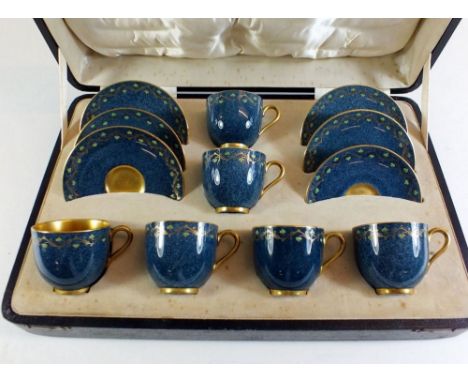 A Royal Worcester set of six coffee cups and saucers in presentation case with stylised heart border on blue ground C2575, wi
