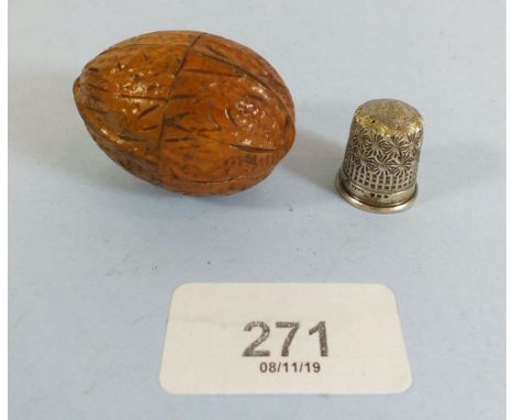 A Victorian carved treen novelty thimble case in the form of a walnut and silver thimble