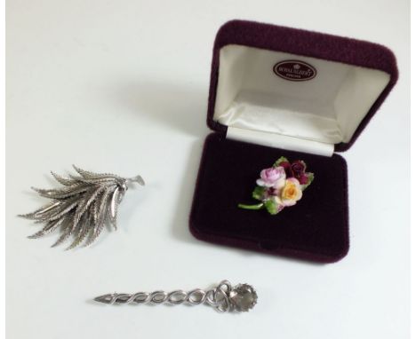 A silver Celtic stone set brooch, a Royal Albert floral spray brooch - boxed, and a leaf brooch