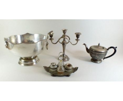 A silver plated punch bowl, cruet stand, teapot and candelabra