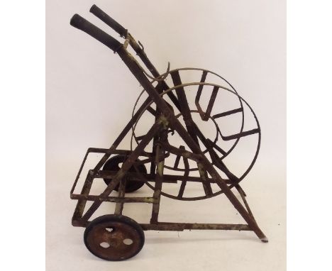 A Victorian cast iron garden hose reel on portable stand