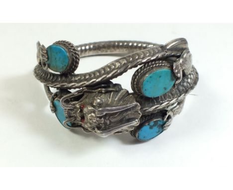 A vintage Chinese white metal dragon form bracelet set turquoise
