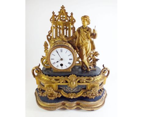 A 19th century French gilt brass mantel clock with young man holding a rake to top, on floral swag base - stamped FH Mouret, 