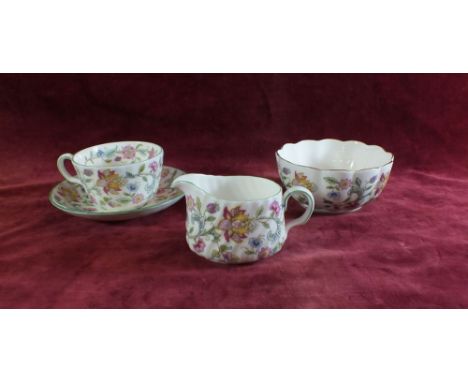 A Minton Haddon Hall tea service comprising: twelve cups and saucers, six tea plates, milk and sugar