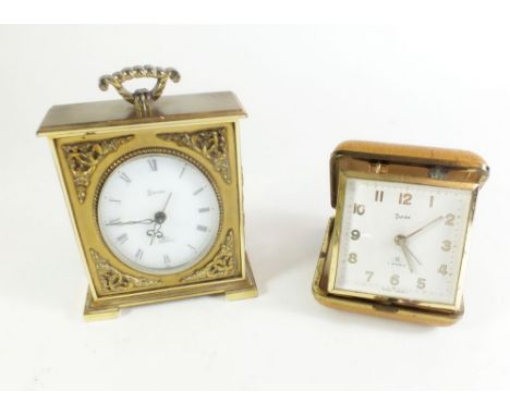 A Swiza brass travelling clock with alarm, and a Swiza cased travelling pocket alarm clock