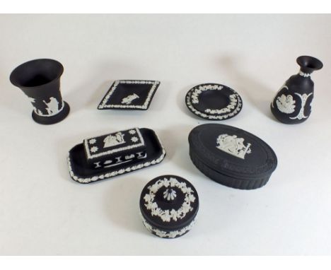 A Wedgwood black Jasperware group of vases, trinket boxes and pin dishes