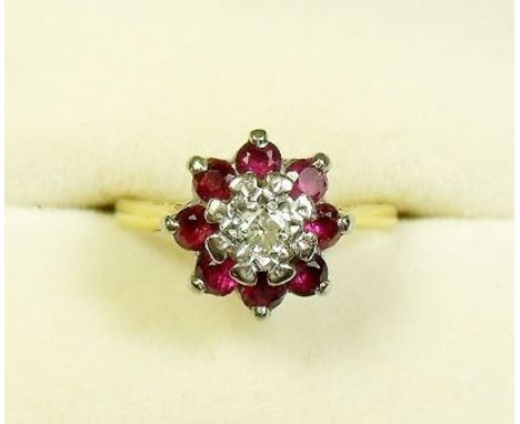 An 18 carat gold ruby and diamond cluster ring - size J 1/2
