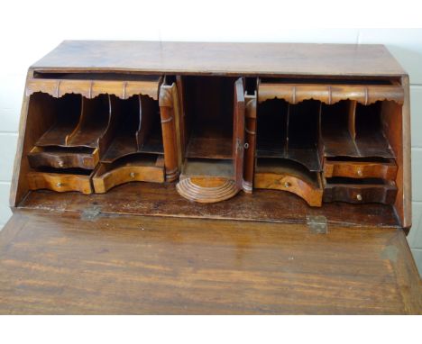 George III mahogany bureau with a good shaped fitted interior with a central panelled door and unusual secret stepped front d