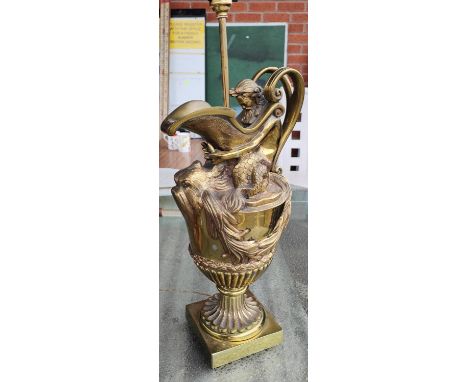A brass jug lamp with ocean decoration in the form of Poseidon, with fish spout 