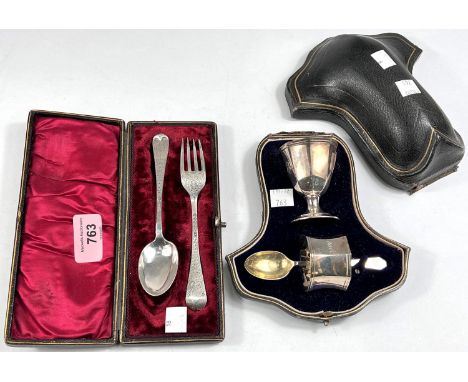 A hallmarked silver 3 piece cased christening set:&nbsp; egg cup, napkin ring and spoon, London 1912; a chased christening se