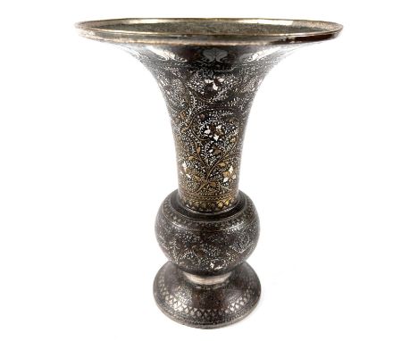 An Indian bronze vase with silver/gilt highlights, flared rim, bulbous body and wide foot