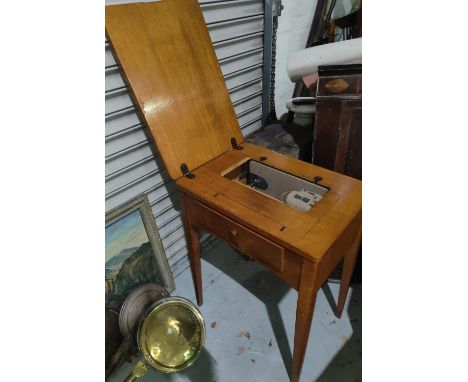 A light oak sewing table with singer machine to the interior 