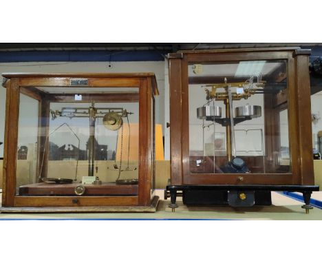 A mahogany and glass cased scientific balance by Griffin &amp; Tatlock; a set of cased laboratory scales by Stanton Instrumen