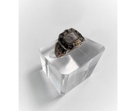 A Victorian mourning ring in yellow metal and black enamel, with enclosed plaited hair, unmarked, tests as 9 carat, 2.8gm 