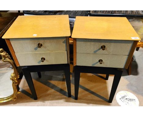 A 1950's pair of designer bedside cabinets in light oak, each with 2 grey drawers, on ebonised bases, and a tray table 