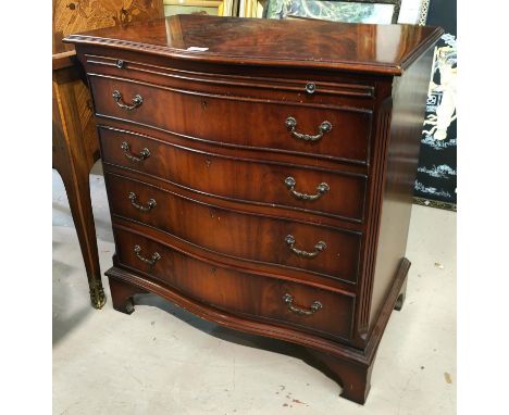 A reproduction mahogany bachelors chest with serpentine front, brushing slide and 4 graduating drawers, on bracket feet, widt