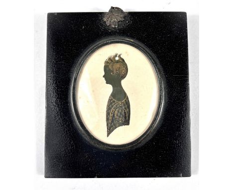 A 19th century silhouette portrait of a young girl in dress with gilt highlights to hair and dress, in ebonised frame, oak le