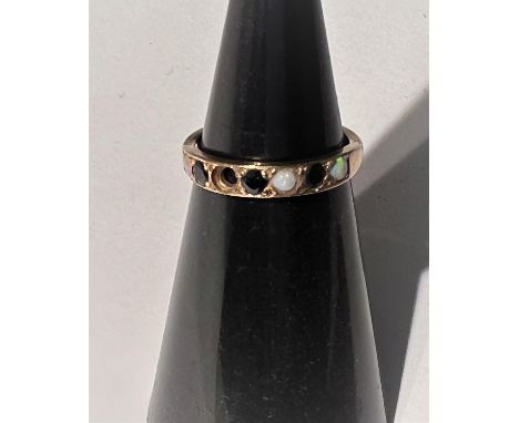 A 9 carat hallmarked gold half eternity ring set 3 sapphires and 4 opals (1 opal missing), 2gm 