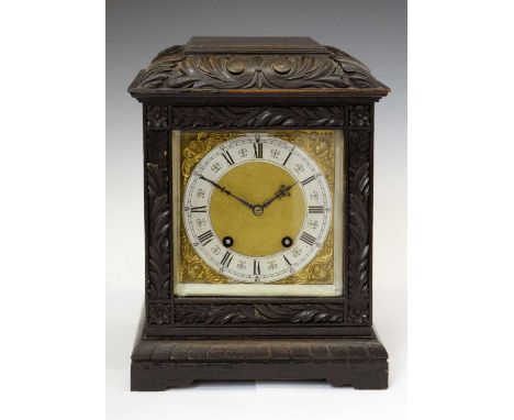 Early 20th century German oak cased mantel clock, having a silvered Roman chapter ring dial with gilt metal masked spandrels,