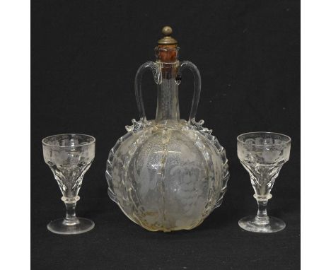 19th century Dutch etched glass decanter with twin handles and applied ripple glass, the globular body having etched scenes o