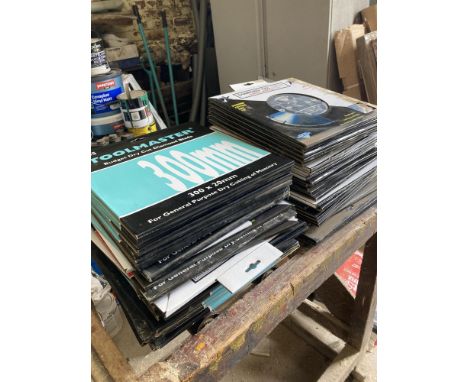 Large collection of cutting discs and roller stand. 