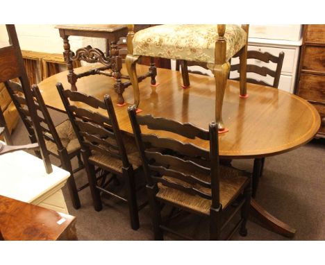 Oval mahogany crossbanded twin pedestal dining table together with set of six country style ladder back rush seated dining ch