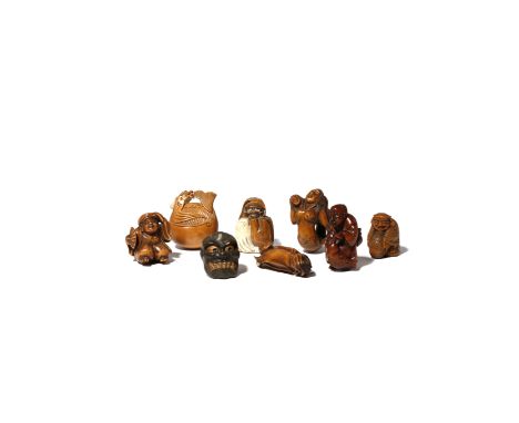 EIGHT JAPANESE WOOD NETSUKE 19TH AND 20TH CENTURY Variously carved as figures, mermaids, a noh mask, a mokugyo bell, and Daru