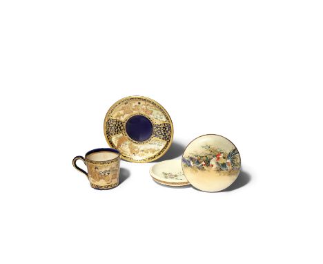 A JAPANESE SATSUMA CUP AND SAUCER BY KINKOZAN MEIJI 1868-1912 Both decorated with two panels in enamels and gilt on a navy-bl