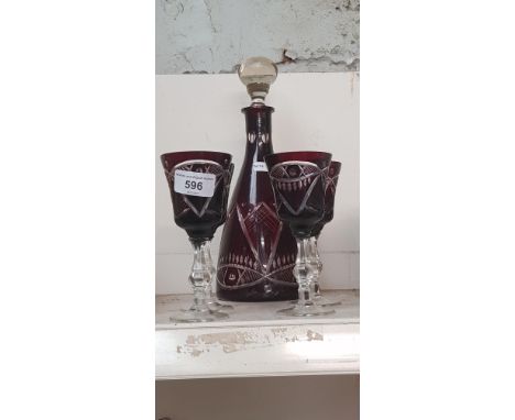 A Bohemian ruby cut glass decanter and glasses. 