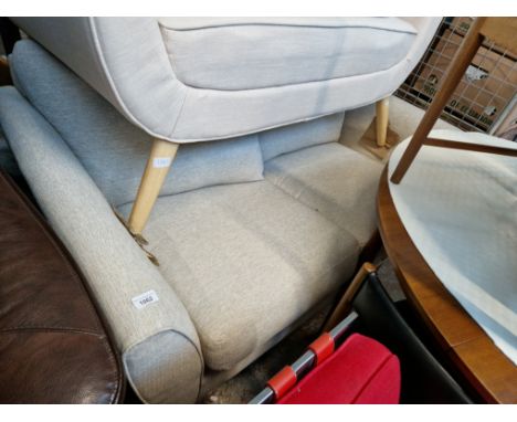 A modern light coloured 2 seater sofa 