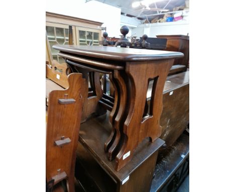 An Ercol dark elm nest of tables and bookcase. Condition- some general wear to the nest of tables, slight splitting to the mi