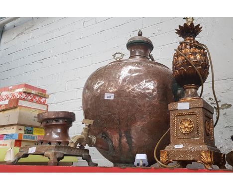 A large round copper urn with brass tap, with a separate copper and brass base, and a brass lamp featuring a pineapple 