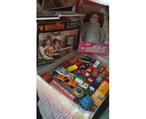 Assorted toys comprising a tray of die-cast model vehicles, a Binatone video game and a German bisque headed doll. 