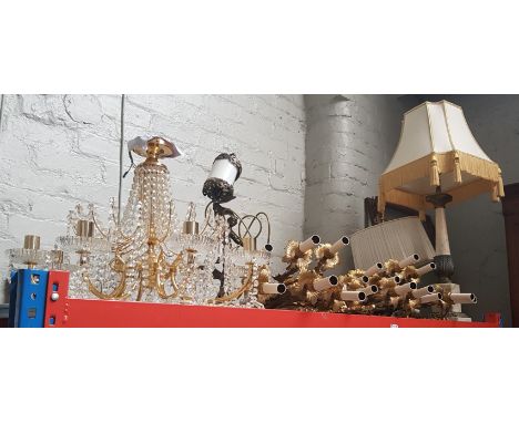 A collection of gilt metal wall lights, a glass drop chandelier, an onyx column table lamp with shade, a metal figural lamp, 