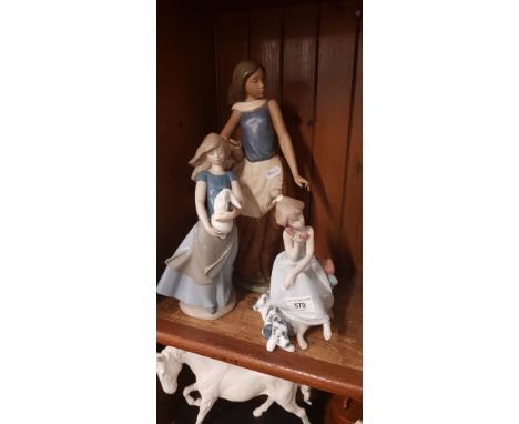 Lladro figure of a girl on the phone and two Nao figures 