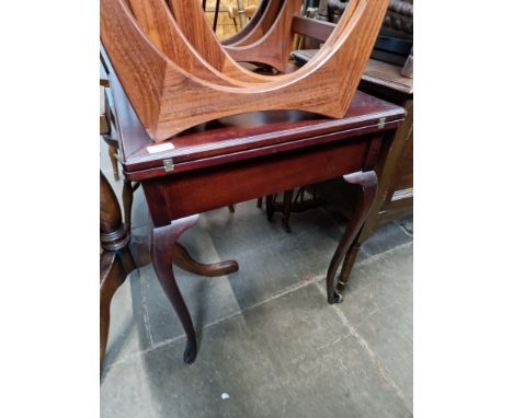 An Edwardian mahogany envelope card table.