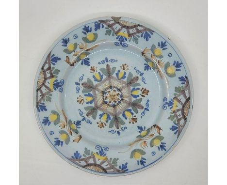 A mid 18th century Lambeth Delftware plate, painted in colours, diameter 22.6cm.Condition note: slight loss of glaze to rim.