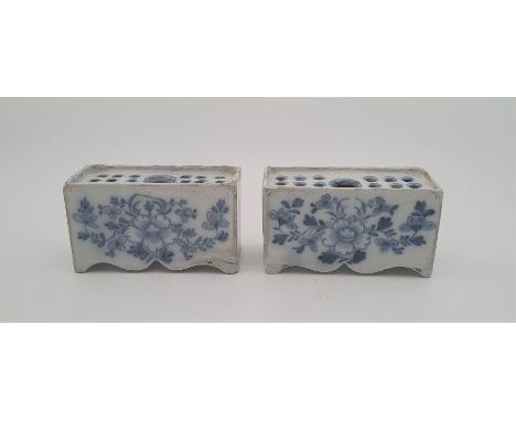 A pair of mid 18th century Liverpool Delftware flower bricks, painted in blue, length 11.5cm.Condition note: both bricks with