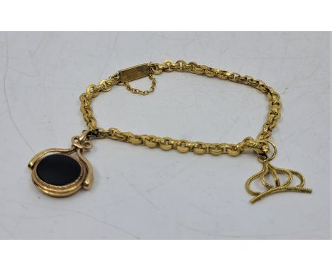 A precious yellow metal fancy link charm bracelet, suspending black onyx and jade set swivel fob and a crown form charm, leng