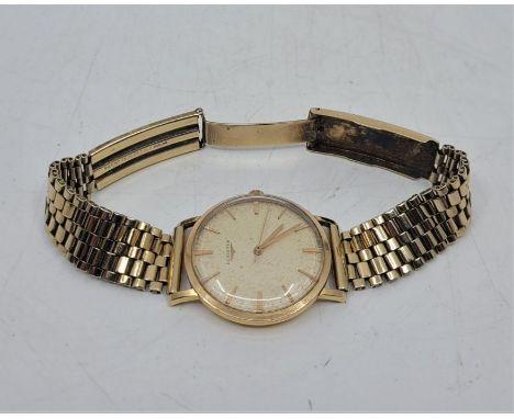A Longines 18ct. gold gentleman's wristwatch, manual movement, having signed circular dial with baton hour markers, 34mm wide