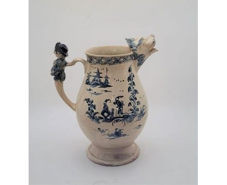 A large 18th century English Delftware water jug, painted in blue, having figural handle and lions mask spout, height 27cm.Co